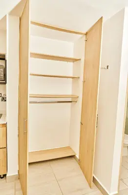 a walk in closet with a wooden door at Apartahotel Castellana in América