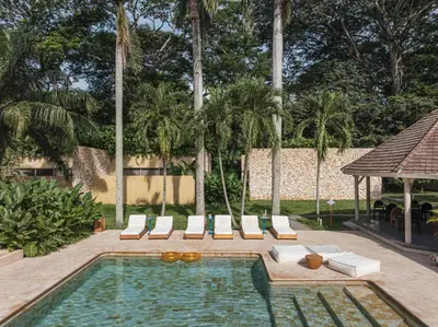 a swimming pool with lounge chairs and a gazebo at Arde La Selva in Santa Fe de Antioquia