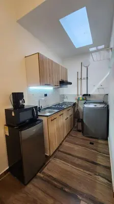 a kitchen with a sink and a dishwasher at Apartamento Envigado wifi 700 mb in Envigado