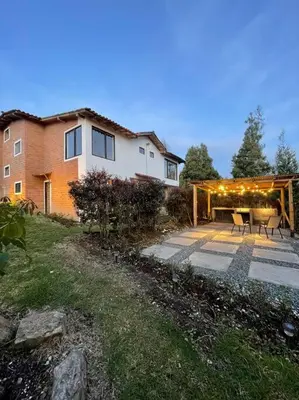 a house with a patio in front of it at Casa de Campo completa ubicada en Santa Elena in Santa Elena