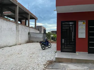 a motorcycle parked next to a red building at Casa de Verano Altos de la Colina-Doradal in Doradal