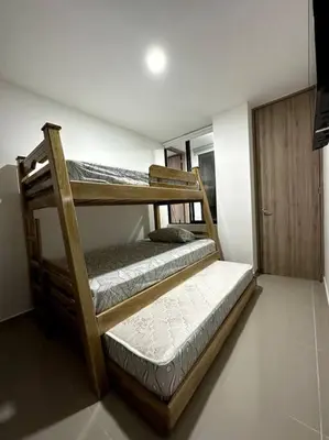two wooden bunk beds in a room with a door at Hermoso Apartamento Entero in Itagüí