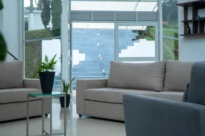 a living room with two couches and a table at Casa de Campo PREMIUN in Guatapé