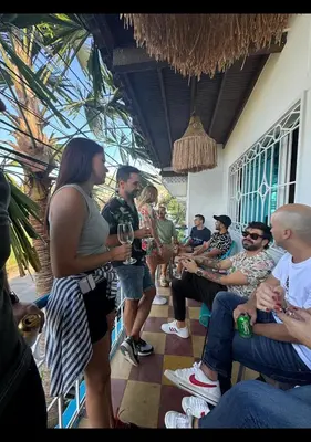 a group of people standing in a room with wine glasses at Lucca Hostel Medellín in Medellín