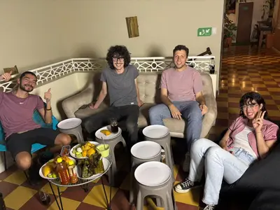 a group of people sitting on a couch at Lucca Hostel Medellín in Medellín