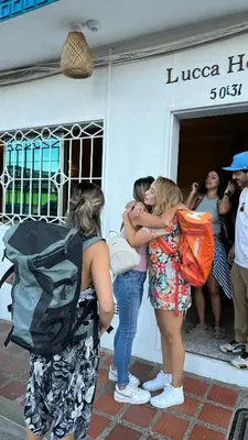 a group of women hugging each other outside a building at Lucca Hostel Medellín in Medellín