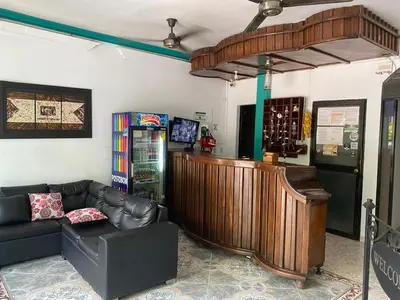 a room with a couch and a counter with wine bottles at Hotel Boyaca in Puerto Boyacá