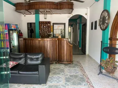 a living room with a leather couch and a bar at Hotel Boyaca in Puerto Boyacá