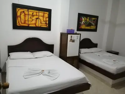 a bedroom with two beds with bows on them at Hotel Boyaca in Puerto Boyacá