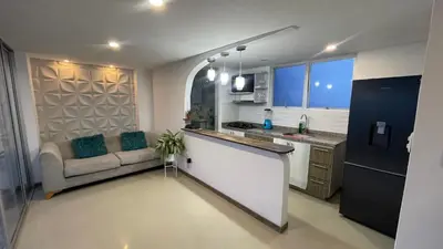 a kitchen and a living room with a couch at Hermoso apartamento en Manizales in Manizales