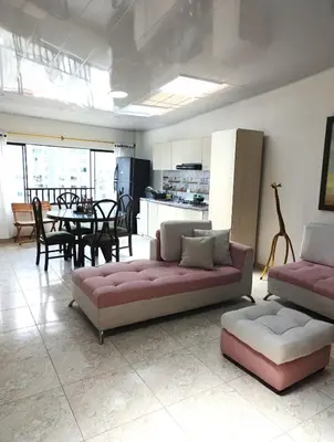 a living room with two couches and a dining room at Comodas y agradables Habitaciones en Chipre in Manizales