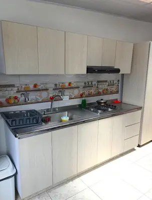 a kitchen with a sink and a stove top oven at Comodas y agradables Habitaciones en Chipre in Manizales