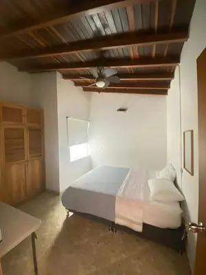 a bedroom with a bed with a wooden ceiling at Residencia Dual Retiro Urbano in Envigado