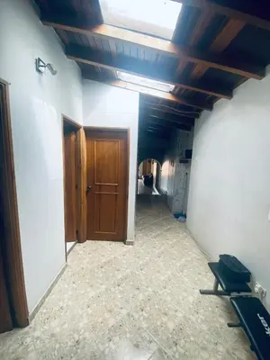an empty hallway with a wooden door and a room at Residencia Dual Retiro Urbano in Envigado