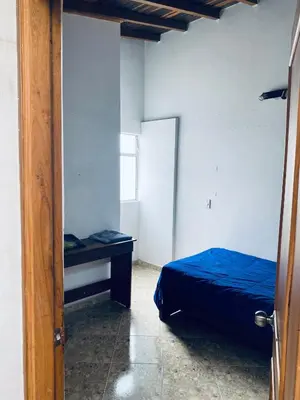 a bedroom with a bed and a desk in it at Residencia Dual Retiro Urbano in Envigado