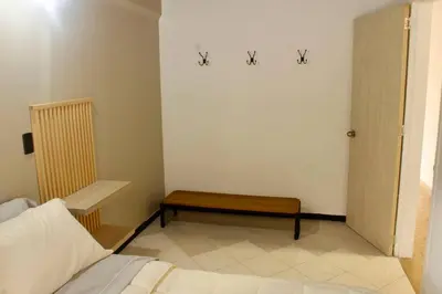 a room with a bed and a bench in it at Casa Primavera in El Poblado