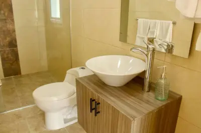 a bathroom with a white sink and a toilet at Casa Primavera in El Poblado