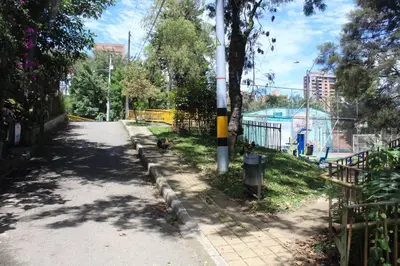 an empty street in a park with a fence at Casa Primavera in El Poblado