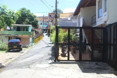 an open door to a street with a house at Casa Primavera in El Poblado