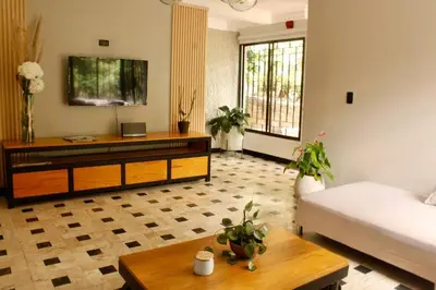 a living room with a couch and a table at Casa Primavera in El Poblado