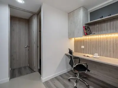 a office with a desk and a chair in a room at Apto nuevo, elegante y cómodo in Medellín
