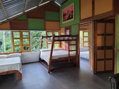 a bedroom with two bunk beds in a room with windows at Finca Familiar Talena in Sopetran