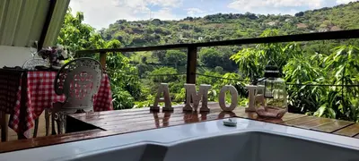 a bath tub sitting on top of a deck with a view at Cómoda y acogedora cerca al Pueblo in Sopetran