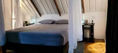 a bedroom with a bed with a blue comforter at Cómoda y acogedora cerca al Pueblo in Sopetran