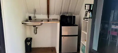 a small kitchen with a sink and a refrigerator at Cómoda y acogedora cerca al Pueblo in Sopetran