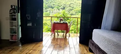 a room with a table on a balcony with a view at Cómoda y acogedora cerca al Pueblo in Sopetran