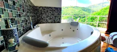 a large white tub in a bathroom with a window at Cabaña en el Aire con jacuzzi a 5min del Pueblo in Sopetran