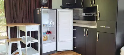 a kitchen with a refrigerator and a microwave at Cabaña en el Aire con jacuzzi a 5min del Pueblo in Sopetran