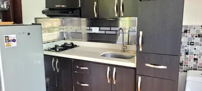 a kitchen with a sink and a refrigerator at Cabaña en el Aire con jacuzzi a 5min del Pueblo in Sopetran