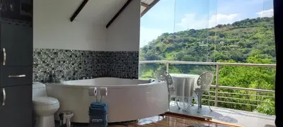 a bath tub in a bathroom with a balcony at Cabaña en el Aire con jacuzzi a 5min del Pueblo in Sopetran