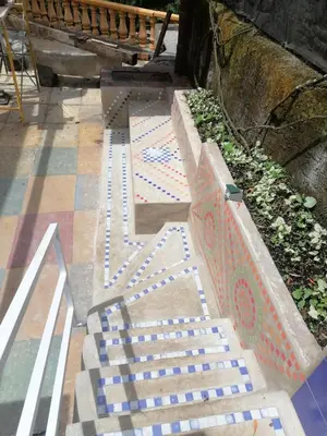 a bench sitting on the ground next to a sidewalk at Ecohotel Otrolado Lodge in Los Andes