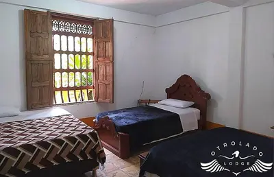a bedroom with two beds and a window at Ecohotel Otrolado Lodge in Los Andes