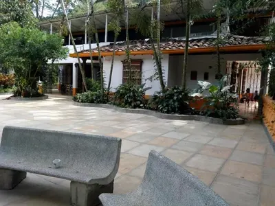 a stone bench sitting in front of a building at Ecohotel Otrolado Lodge in Los Andes