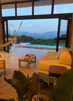 a bedroom with a bed and a view of a pool at Finca Calathea in Marsella