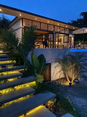 a house with stairs and lights in front of it at Finca Calathea in Marsella