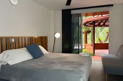 a bedroom with a bed and a couch and a patio at Casa Palos Altos; Poblado; 6 min de Provenza; in El Poblado