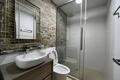 a bathroom with a sink and a glass shower at Casa Palos Altos; Poblado; 6 min de Provenza; in El Poblado