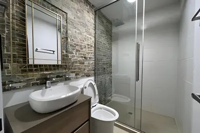 a bathroom with a sink and a toilet and a mirror at Casa Palos Altos; Poblado; 6 min de Provenza; in El Poblado