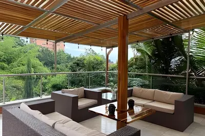 an outdoor patio with couches and a table at Casa Palos Altos; Poblado; 6 min de Provenza; in El Poblado