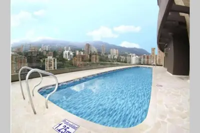 a large swimming pool on top of a building at Class suites nirvana in El Poblado