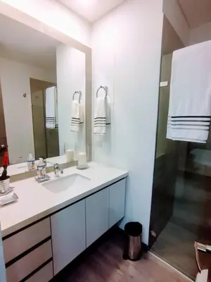 a white bathroom with a sink and a shower at Class suites nirvana in El Poblado