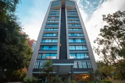 a tall building with a lot of windows on it at Class suites nirvana in El Poblado