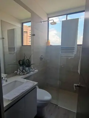 a bathroom with a shower and a toilet and a sink at Class suites nirvana in El Poblado