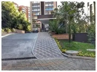 an empty street in front of a building at Class suites nirvana in El Poblado