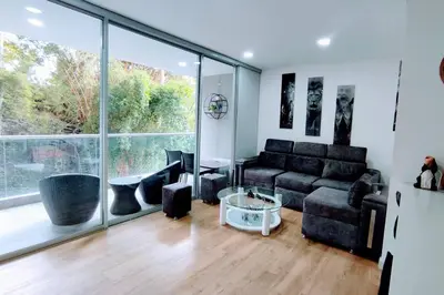 a living room with a couch and a large window at Urban studios luxurious apartment in the poblado in Medellín