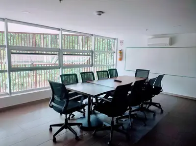 a conference room with a long table and chairs at Urban studios luxurious apartment in the poblado in Medellín